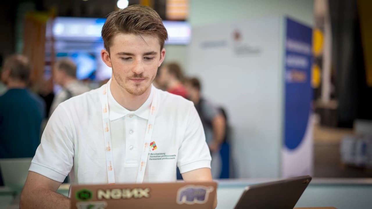 Jannis smiling at his SwissSkills competition booth.